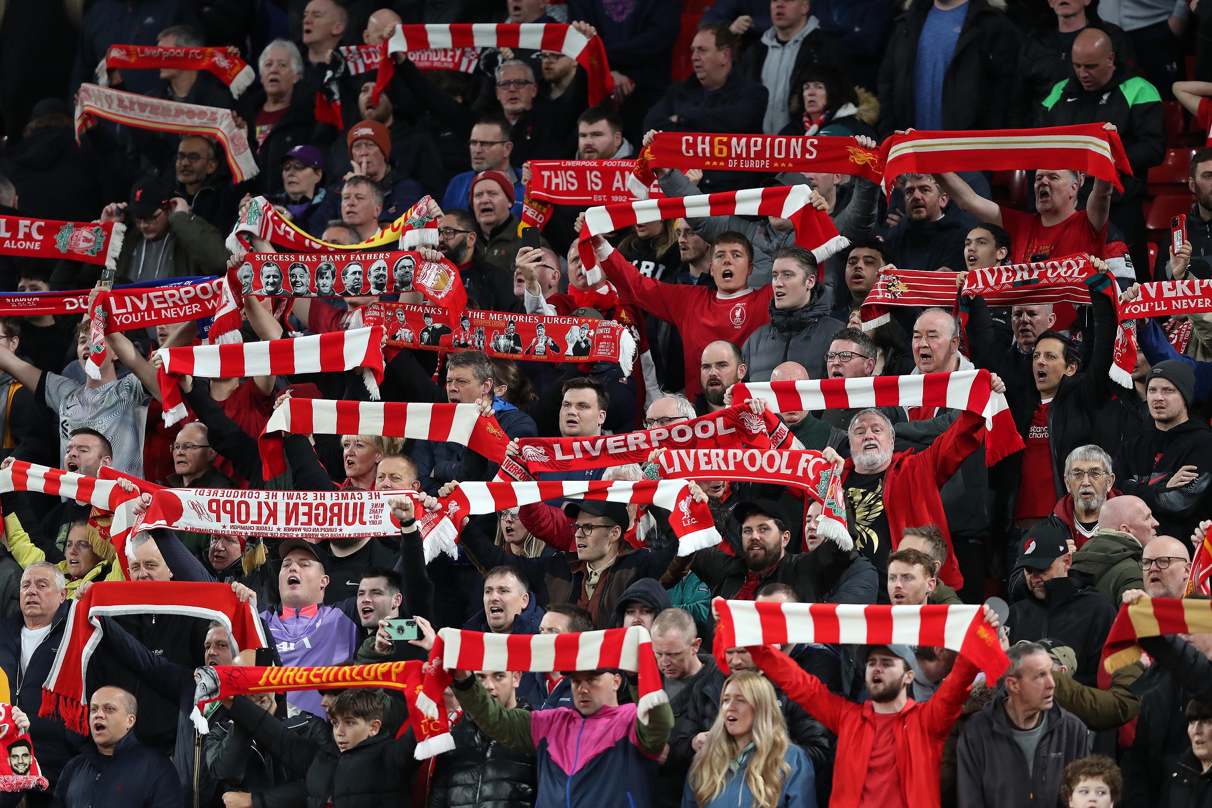 LIVERPOOL, ENGLAND - APRIL 11: Liverpool fans hold aloft scarves in the Kop Stand ahead of kick off during the UEFA Europa League 2023/24 Quarter-Final first leg match between Liverpool FC and Atalanta at Anfield on April 11, 2024 in Liverpool, England.(Photo by Crystal Pix/MB Media/Getty Images)